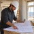 Architect or civil engineer reviewing plans in an office