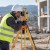 Surveyors using measurement and surveying equipment outdoors